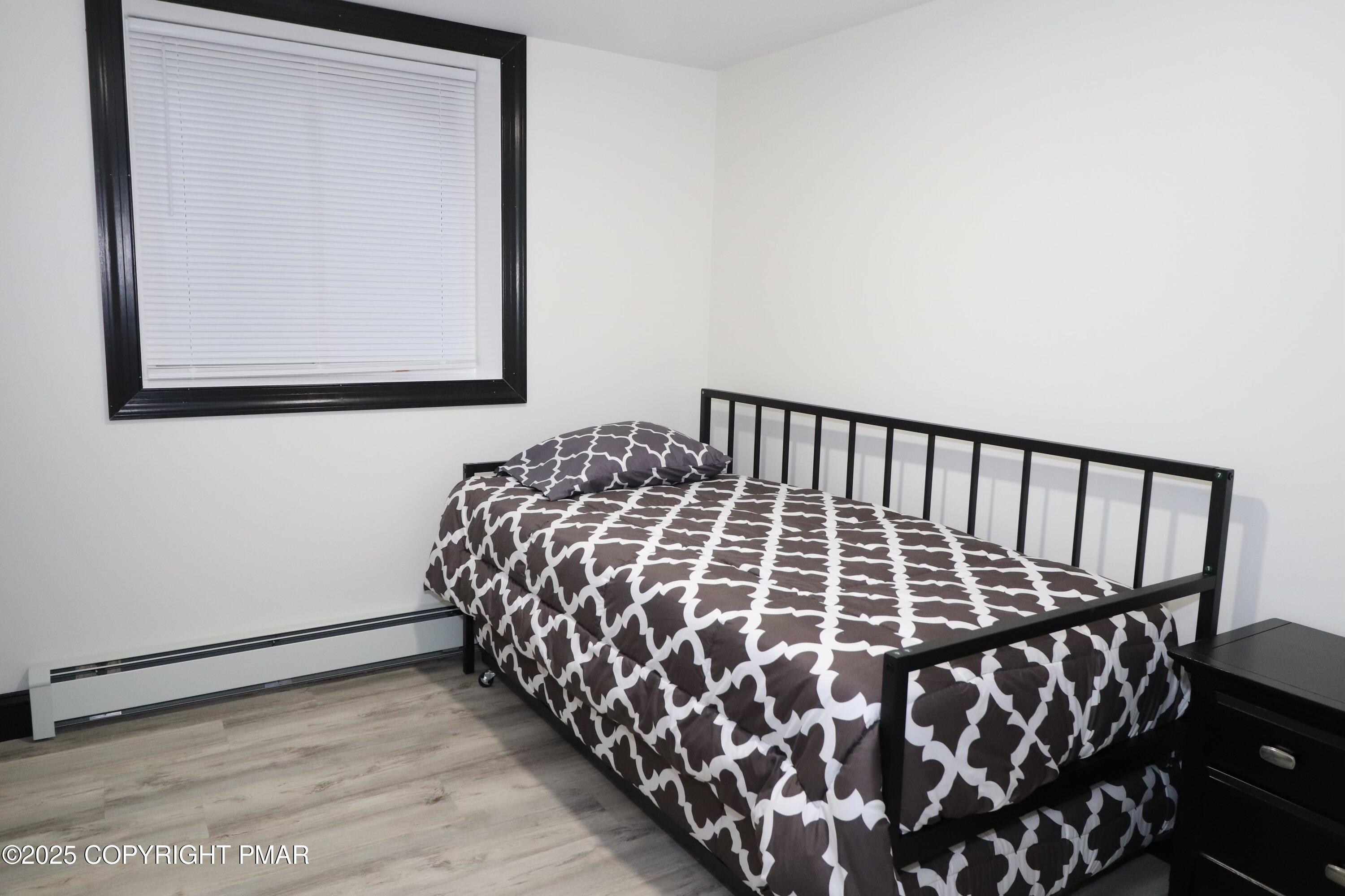 101 Antler Rdg Court Hawley, PA 18428 - Photo 31 of 36 a bedroom with a bed and painting on the wall