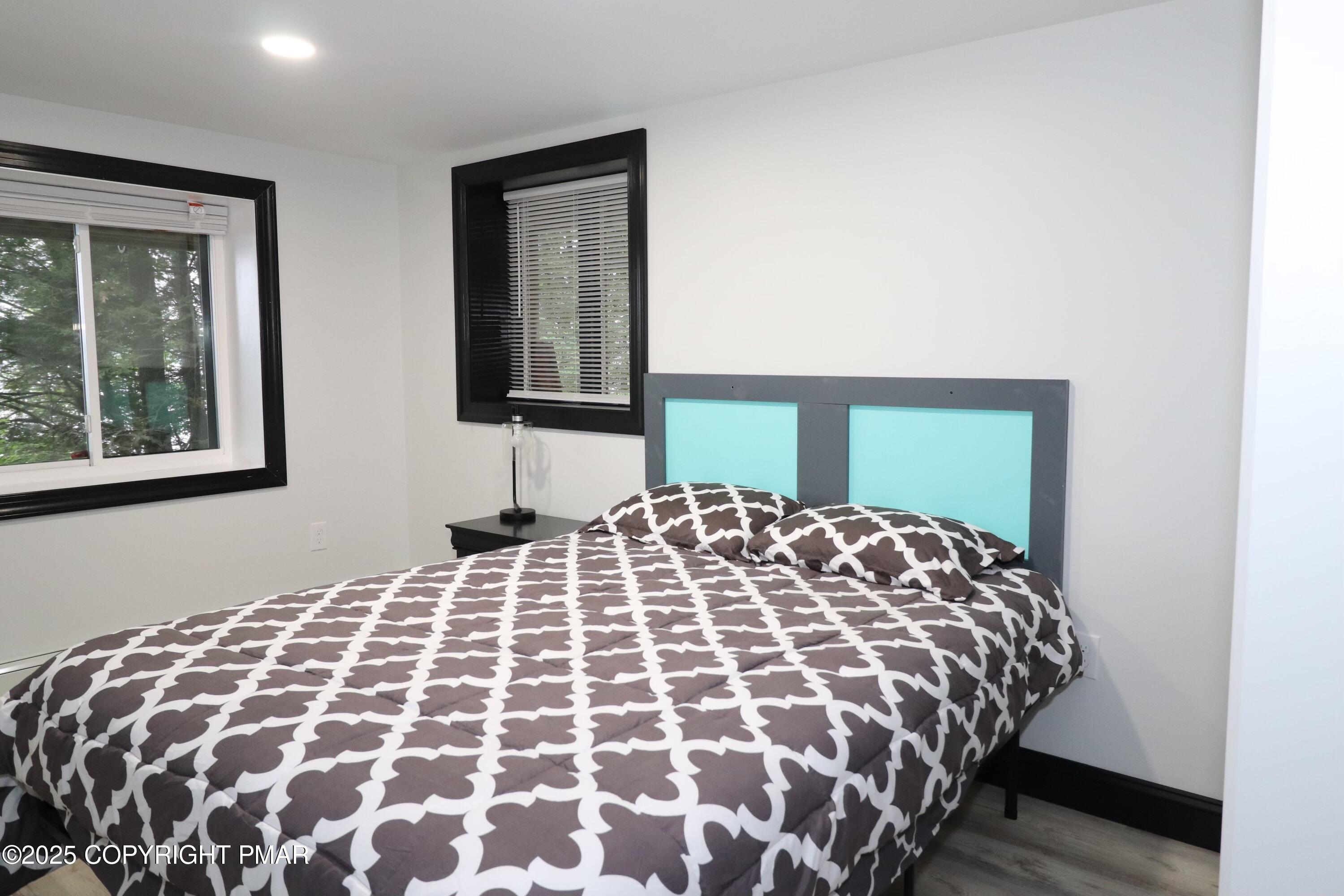 101 Antler Rdg Court Hawley, PA 18428 - Photo 35 of 36 a bedroom with a large bed and a window