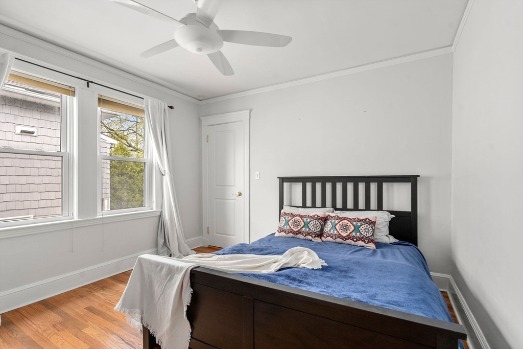 35-37 Presentation Road Boston, MA 02135 - Photo 21 of 29 a bed sitting in a bedroom next to a window