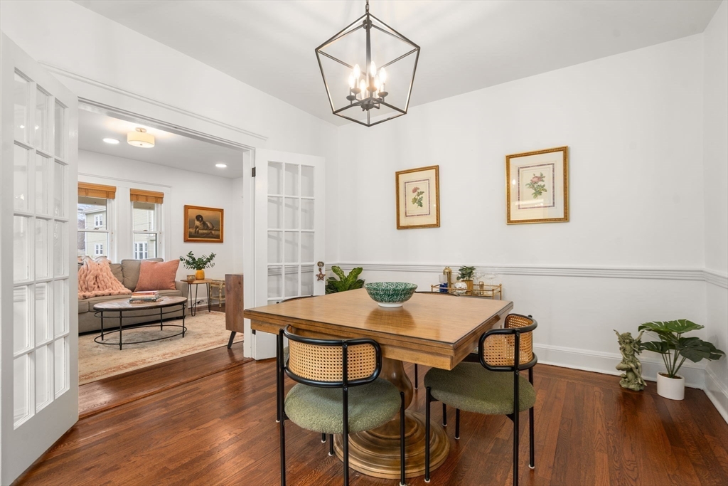35-37 Presentation Road Boston, MA 02135 - Photo 6 of 29 a view of a dining room with furniture wooden floor and a chandelier