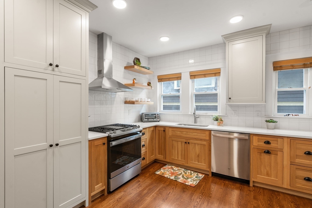 35-37 Presentation Road Boston, MA 02135 - Photo 8 of 29 a kitchen with granite countertop stainless steel appliances a sink and cabinets