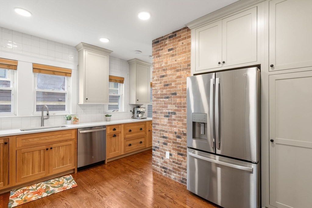 35-37 Presentation Road Boston, MA 02135 - Photo 9 of 29 a kitchen with stainless steel appliances a refrigerator sink and cabinets