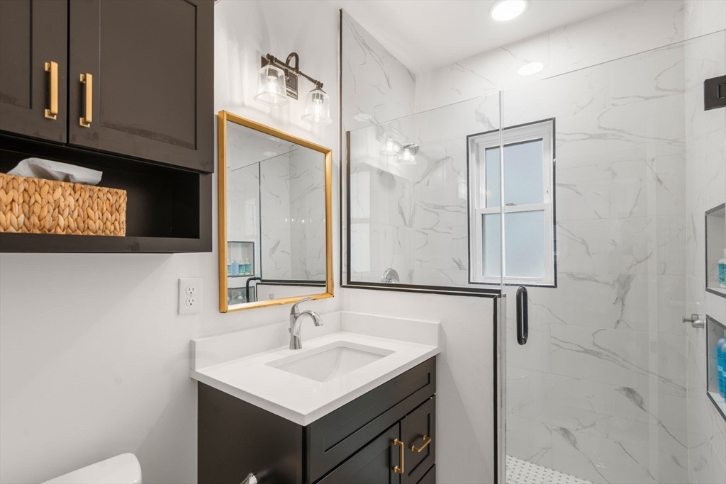35-37 Presentation Road Boston, MA 02135 - Photo 10 of 29 a bathroom with a sink and a mirror