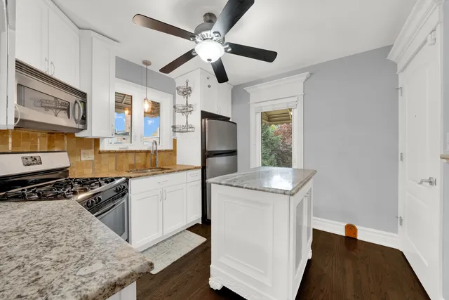 a kitchen with stainless steel appliances granite countertop a stove and a sink