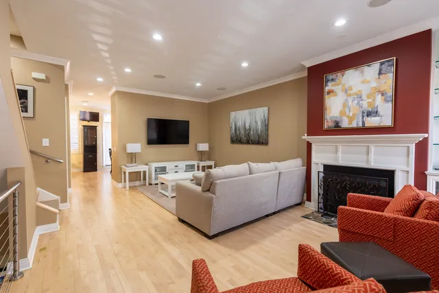 a living room with furniture a flat screen tv and a fireplace