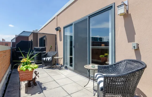 a outdoor space with a table and chairs