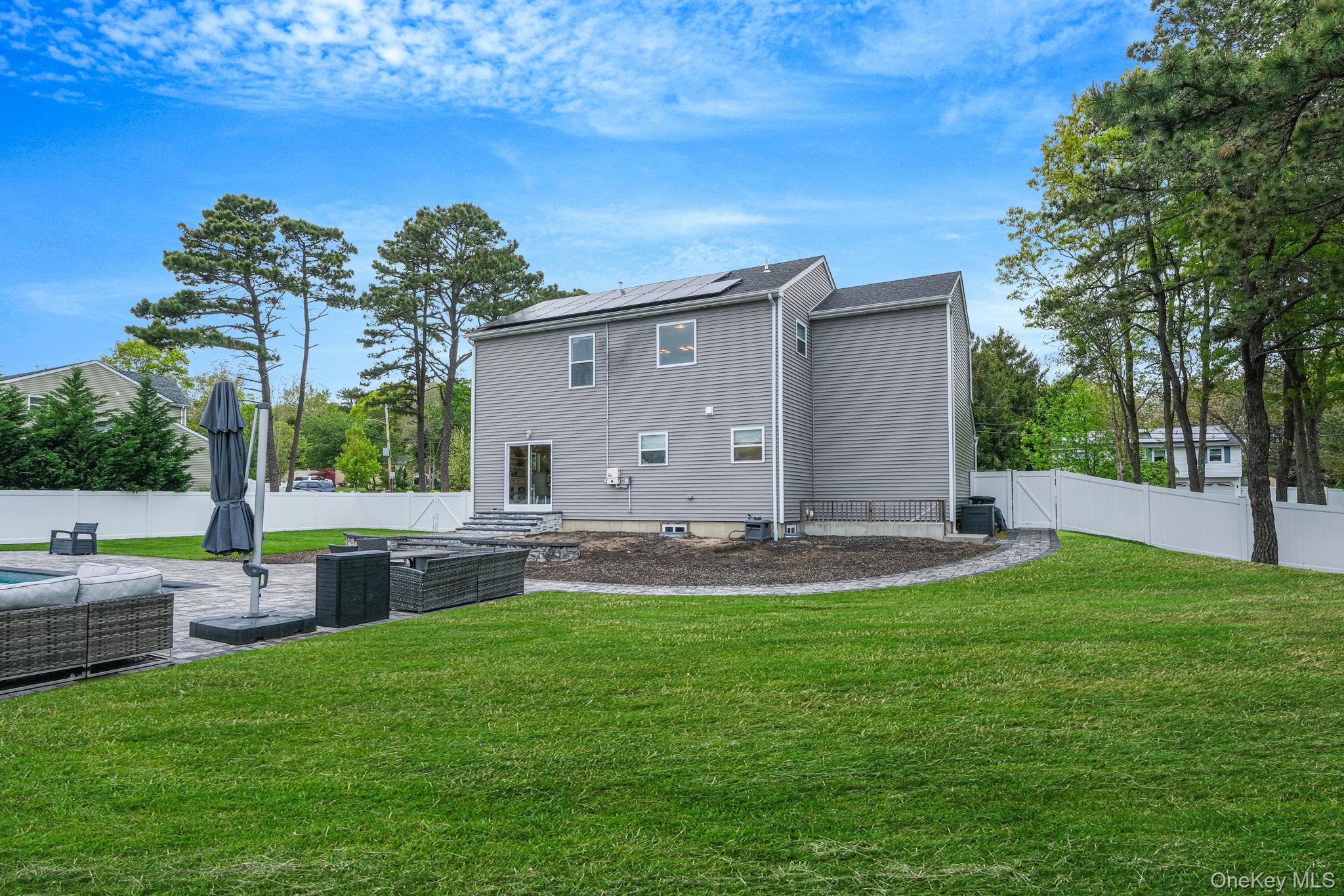 86 Country Road Medford, NY 11763 - Photo 11 of 47 .52 acres with 44’ x 20’ gas-heated Jandy TruGuard mineral in-ground pool with a 10’ sundeck, lounge area, and gorgeous waterfall feature