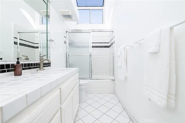 a bathroom with a sink a mirror and a bathtub
