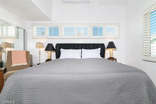 a bedroom with a large bed and a window