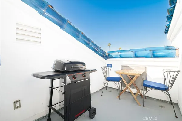 a view of a chairs and table in patio
