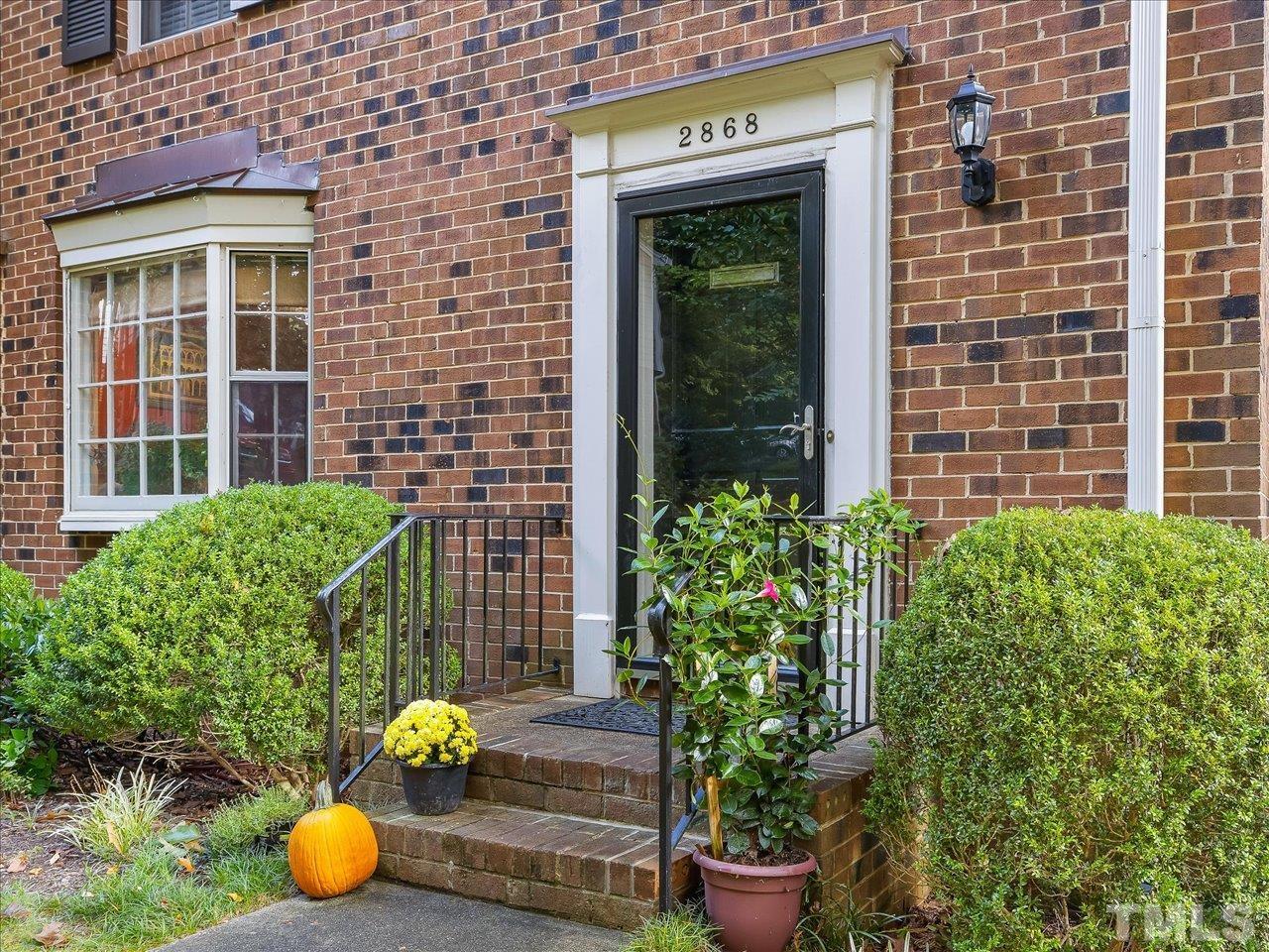 2868 Wycliff Road Raleigh, NC 27607 - Photo 2 of 28 a potted plant sitting in front of a building