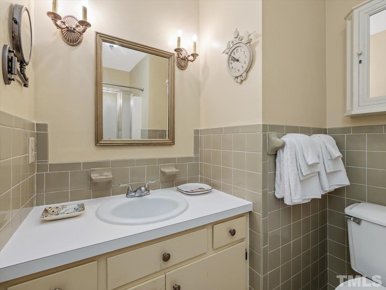 2868 Wycliff Road Raleigh, NC 27607 - Photo 14 of 28 a bathroom with a sink vanity and shower