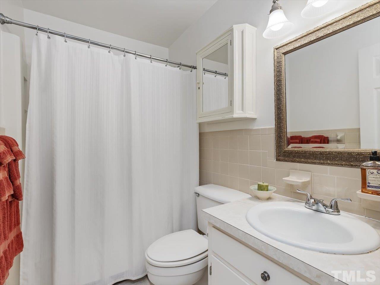 2868 Wycliff Road Raleigh, NC 27607 - Photo 16 of 28 a bathroom with a sink toilet and mirror