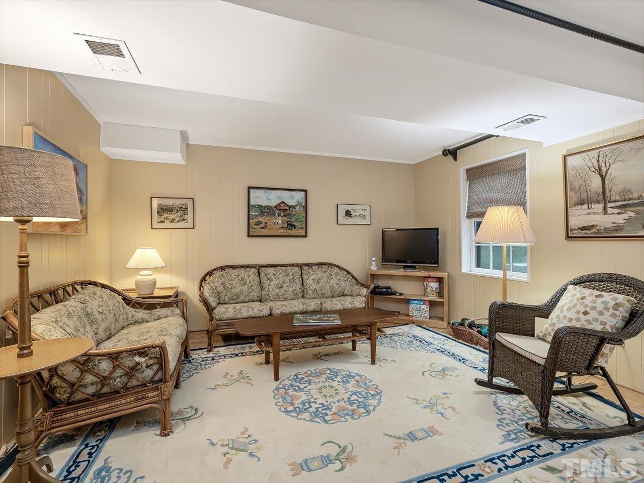 2868 Wycliff Road Raleigh, NC 27607 - Photo 19 of 28 a living room with furniture and a flat screen tv