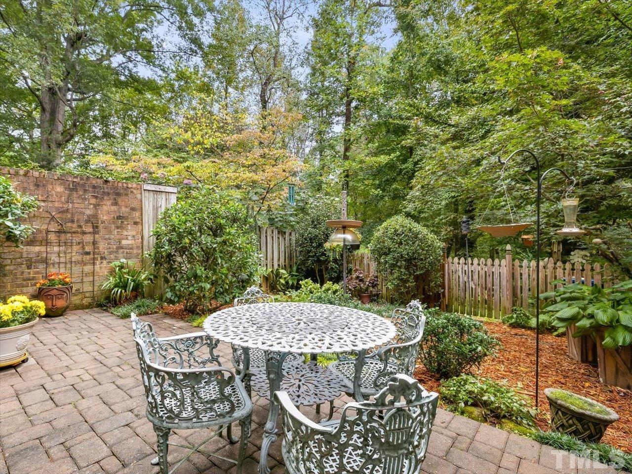 2868 Wycliff Road Raleigh, NC 27607 - Photo 23 of 28 a view of a patio with table and chairs potted plants and tree