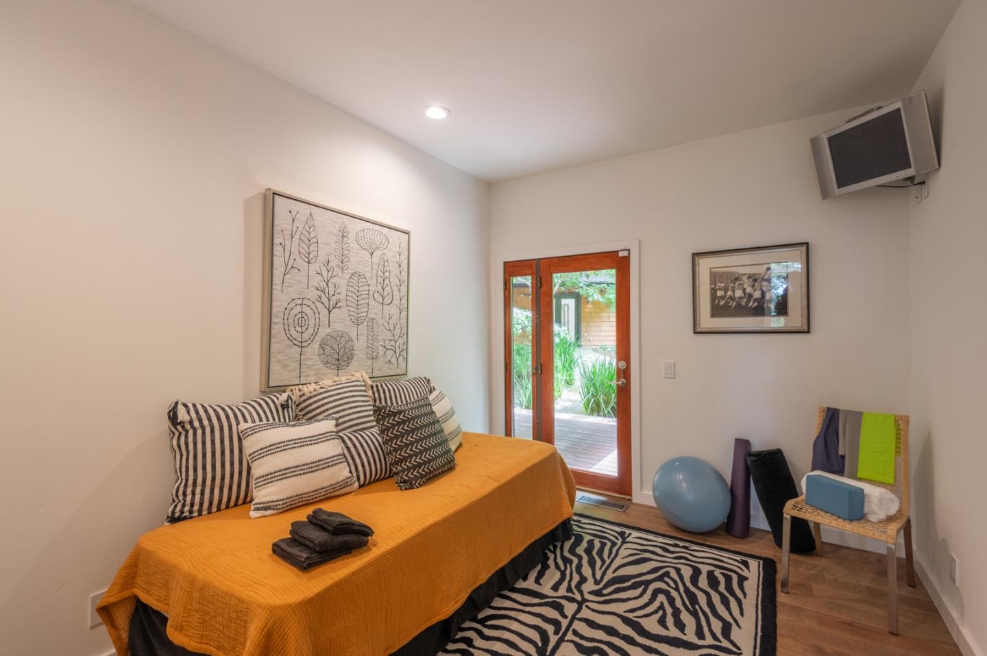 29705 Peter Pan Road Carmel, CA 93923 - Photo 21 of 51 a bedroom with a bed and wooden floor