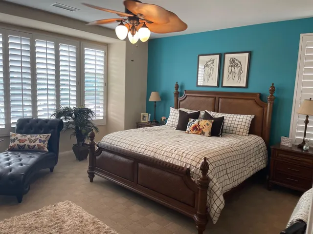 a bedroom with a bed a couch and dresser