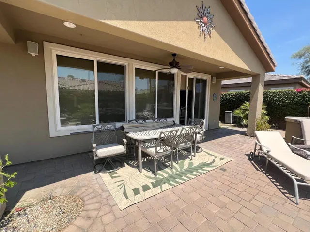 a building outdoor space with patio furniture and potted plants