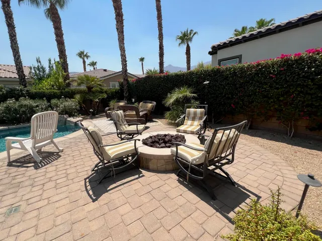 a view of a patio with furniture and plants