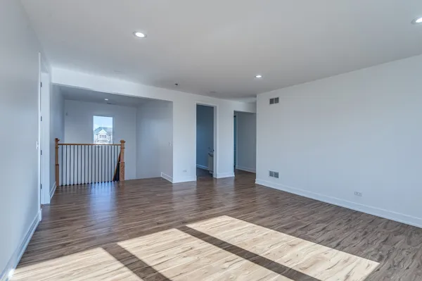 a view of an empty room and wooden floor