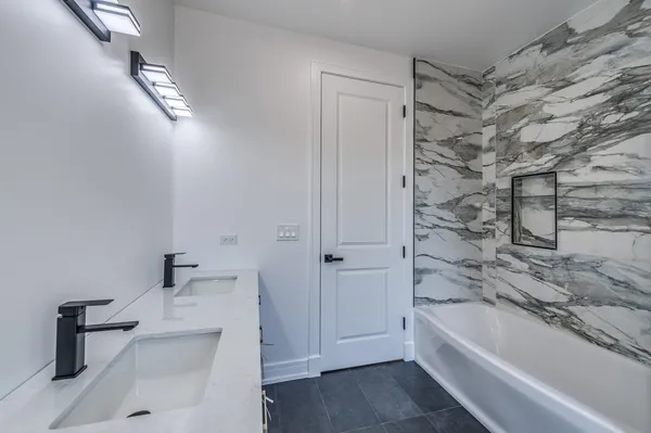 a bathroom with a bathtub and a shower