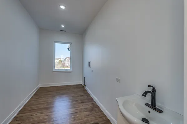 a view of a room with wooden floor and window