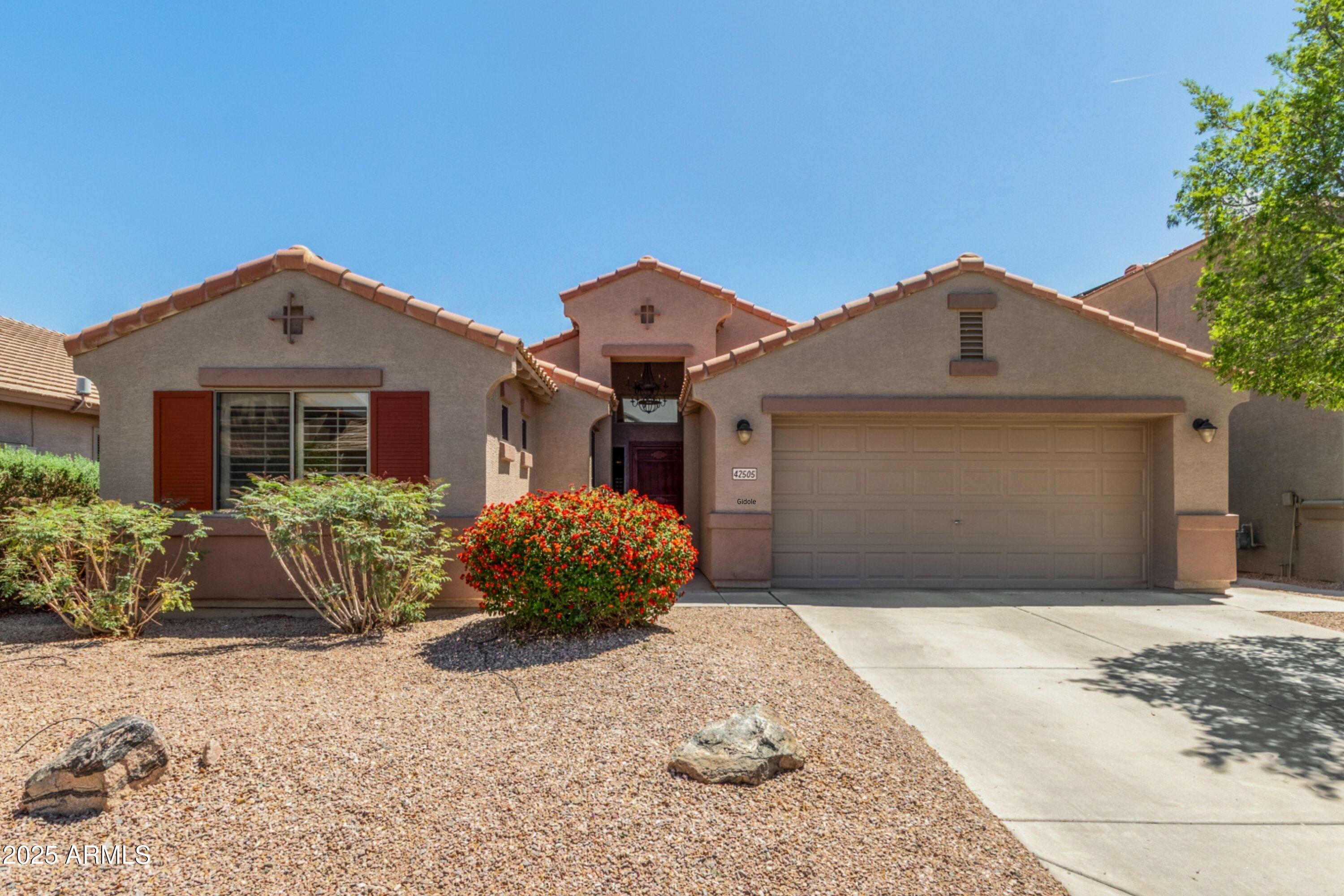 42505 West Venture Road Maricopa, AZ 85138 - Photo 1 of 11 a front view of a house with garden