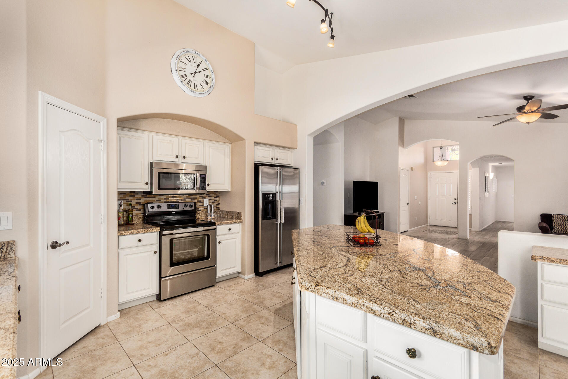 42505 West Venture Road Maricopa, AZ 85138 - Photo 3 of 11 a kitchen with stainless steel appliances granite countertop a sink stove and refrigerator