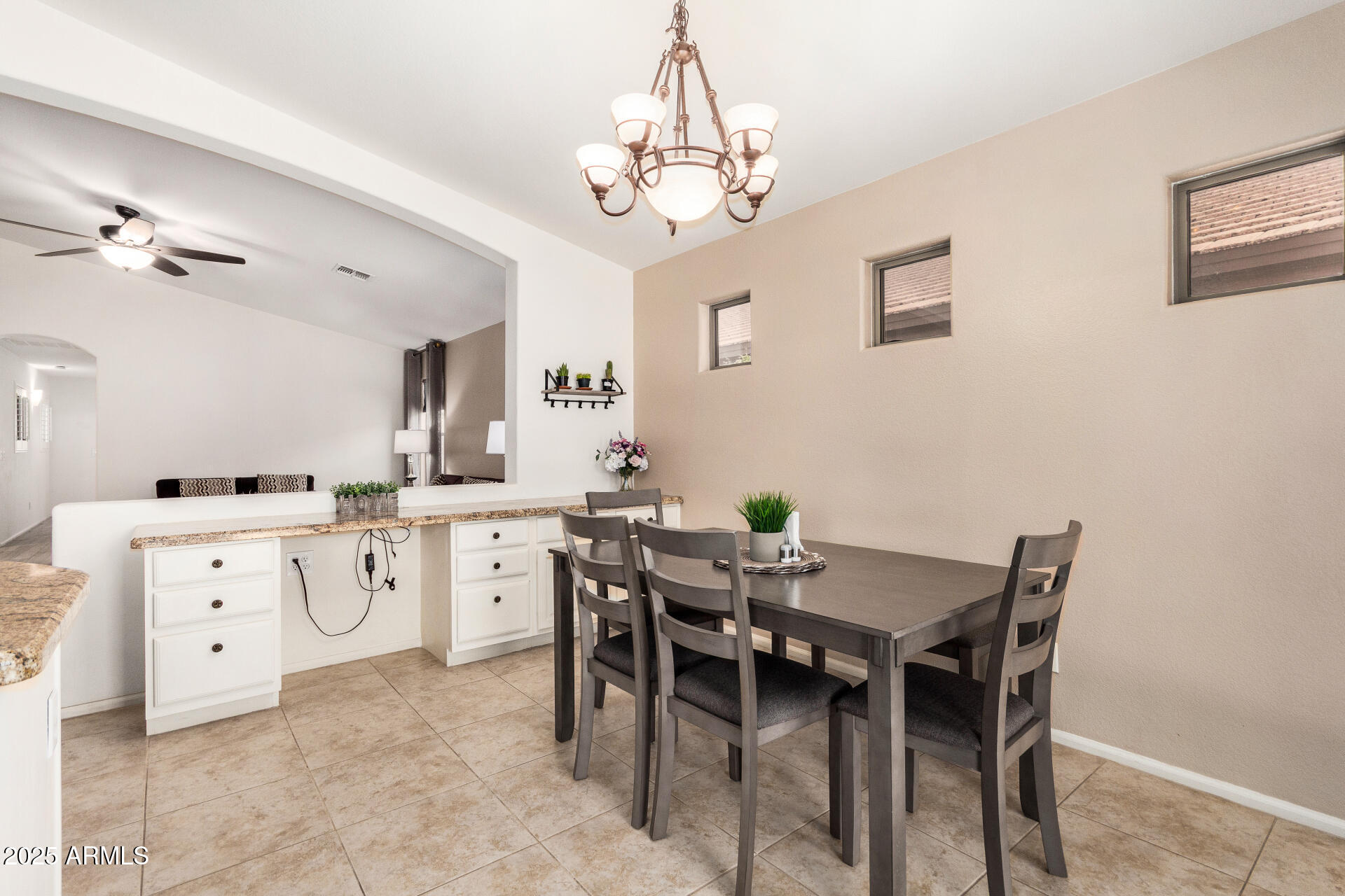 42505 West Venture Road Maricopa, AZ 85138 - Photo 4 of 11 a view of a dining room with furniture and chandelier