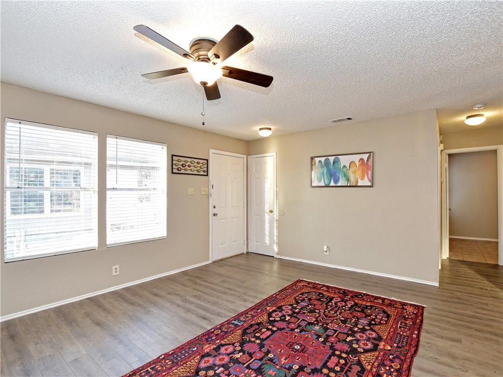 5401 Spring Meadow Road, Unit B Austin, TX 78744 - Photo 3 of 21 A welcoming living area boasts durable laminate flooring, a cooling ceiling fan, and ample natural light.