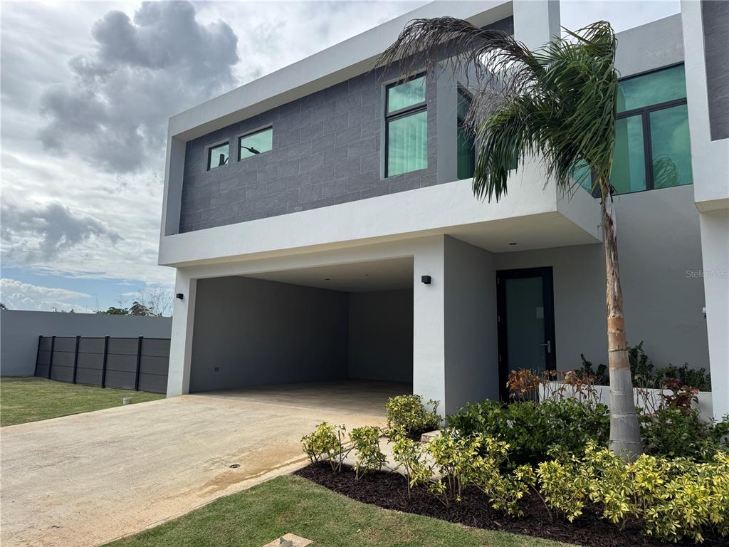 The Villas The Villas At Rio, Unit 96 Bayamon, PR 00959 - Photo 1 of 1 a front view of a house with a yard