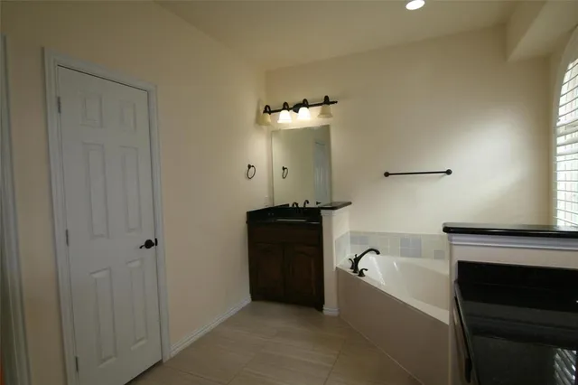 a bathroom with a bathtub and a sink