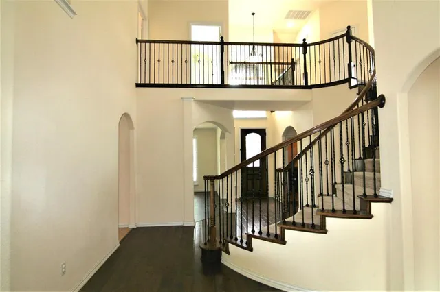 a view of staircase with lots of frames on wall and a window