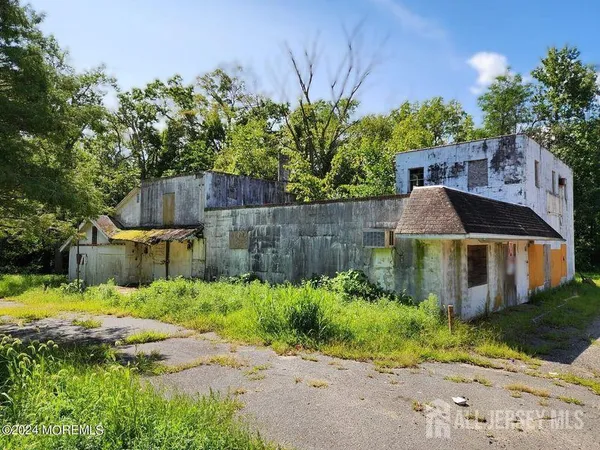 a view of a house with a yard and sitting area