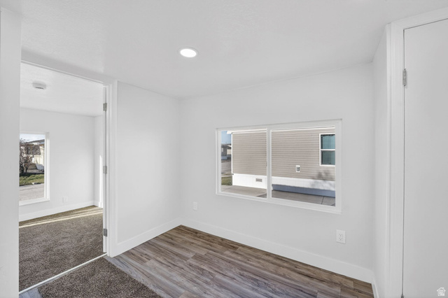 2491 Highway 89, Unit 523 Pleasant View, UT 84404 - Photo 12 of 31 Spare room featuring wood finished floors and healthy amount of natural light