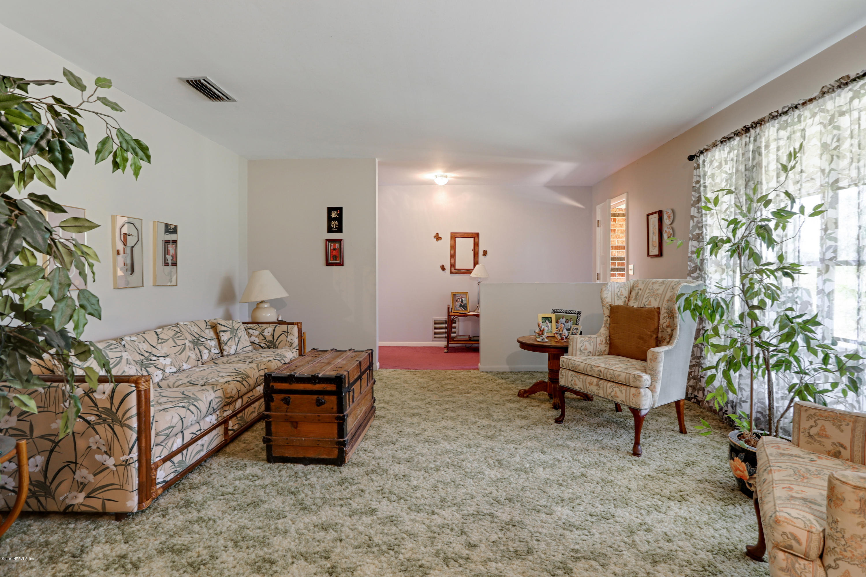 986 Bea Lane Jacksonville, FL 32220 - Photo 15 of 42 a bedroom with furniture and a potted plant