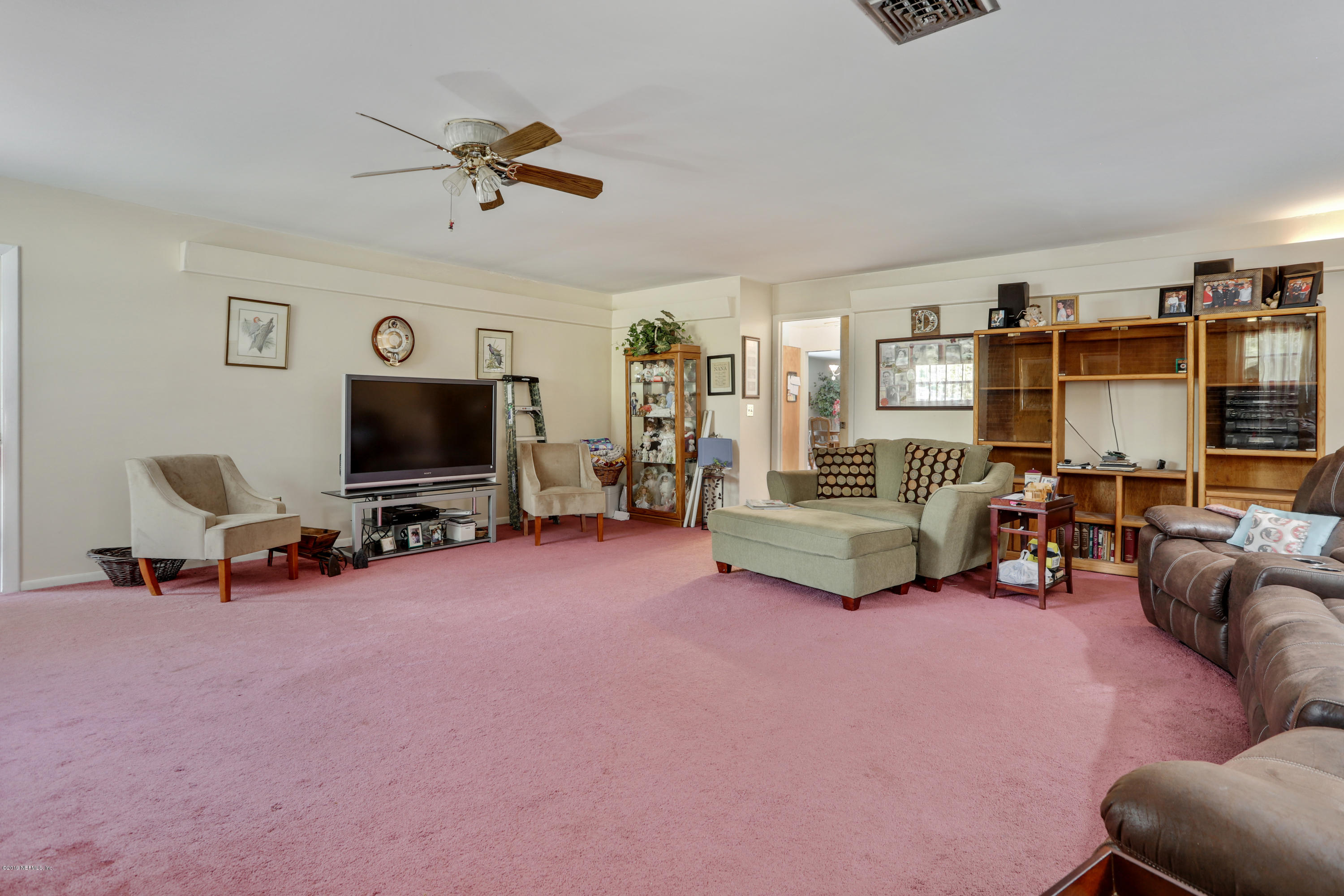 986 Bea Lane Jacksonville, FL 32220 - Photo 17 of 42 a living room with furniture and a flat screen tv