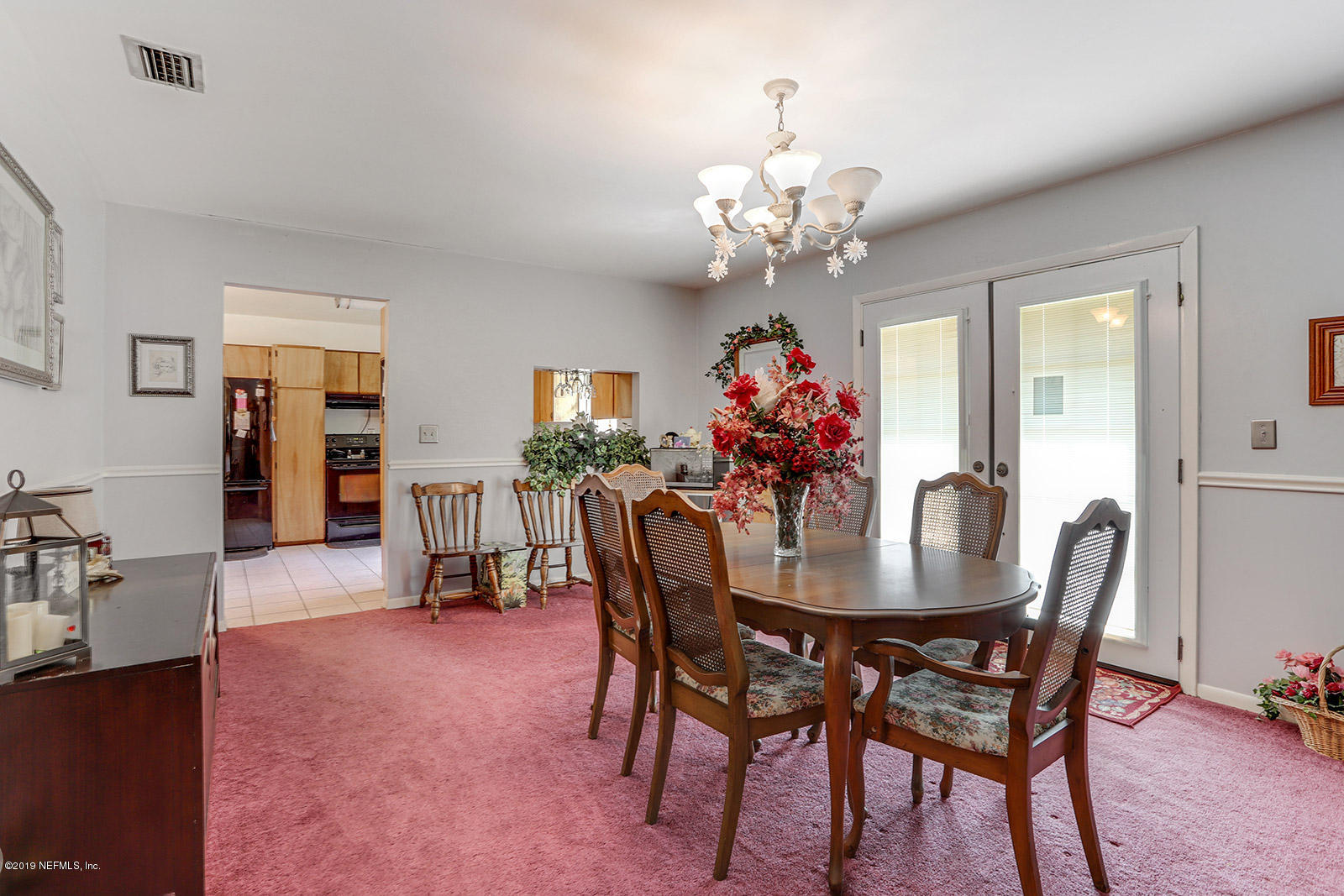 986 Bea Lane Jacksonville, FL 32220 - Photo 18 of 42 a view of a dining room with furniture and chandelier