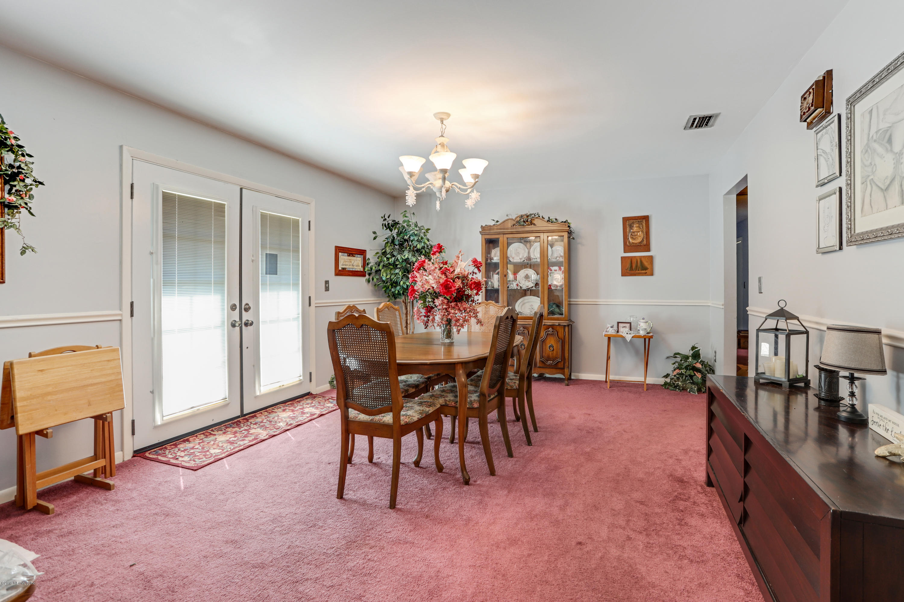 986 Bea Lane Jacksonville, FL 32220 - Photo 19 of 42 a dining room with furniture and chandelier