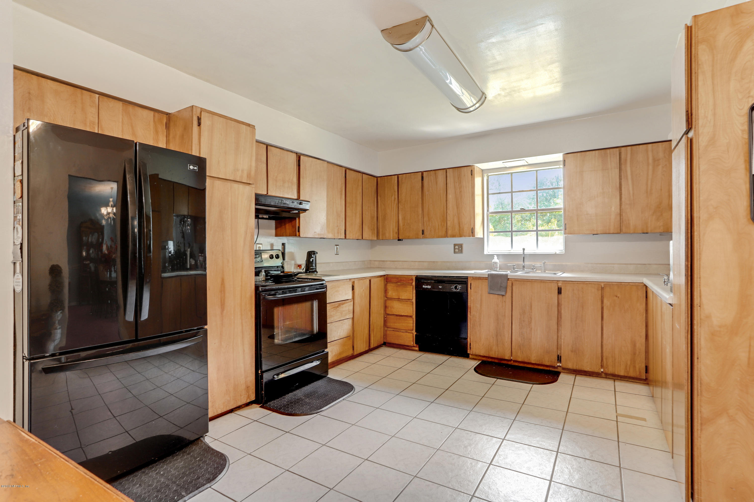 986 Bea Lane Jacksonville, FL 32220 - Photo 20 of 42 a kitchen with stainless steel appliances granite countertop a refrigerator and a stove top oven