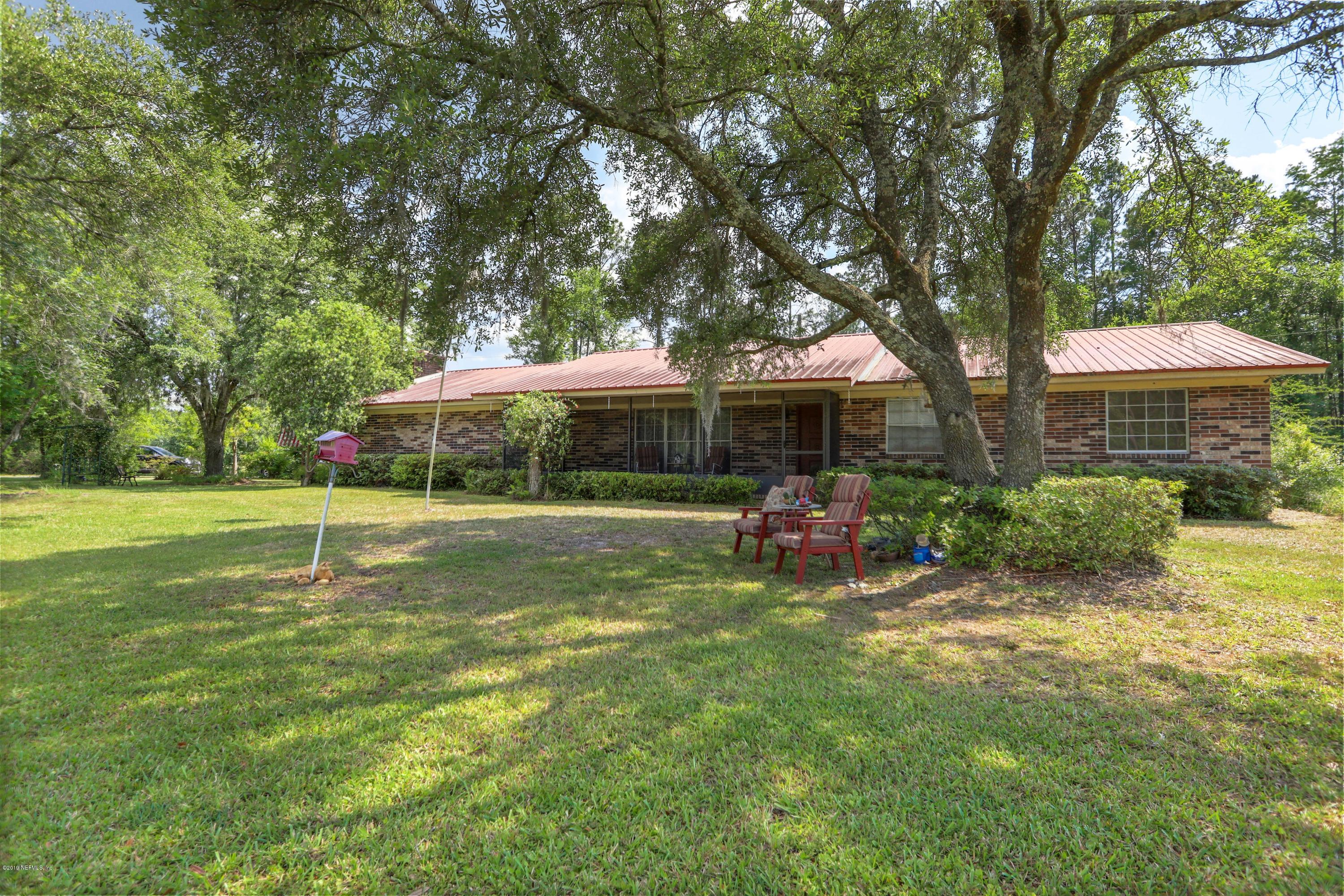 986 Bea Lane Jacksonville, FL 32220 - Photo 2 of 42 a view of a house with a yard porch and sitting area