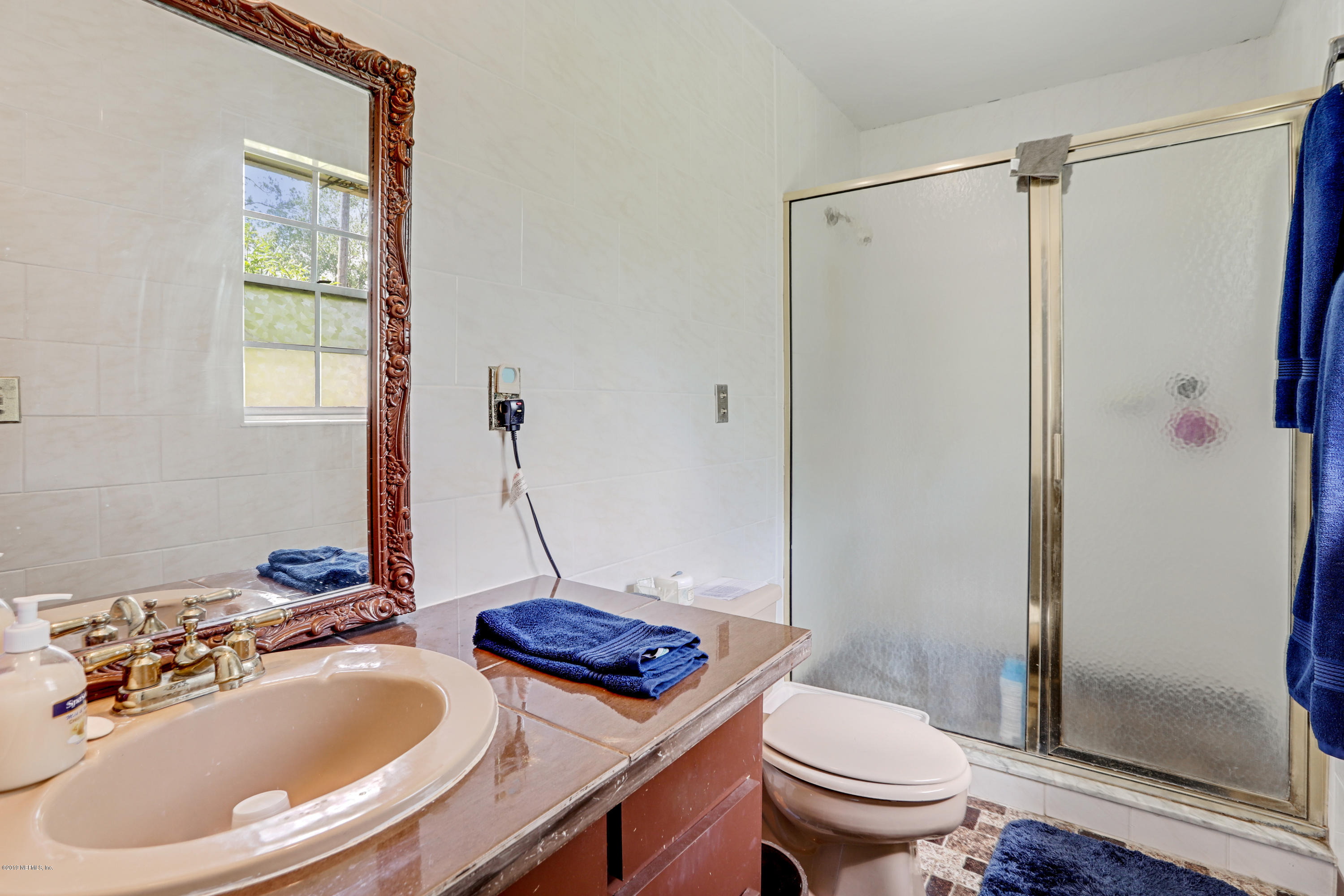 986 Bea Lane Jacksonville, FL 32220 - Photo 24 of 42 a bathroom with a sink toilet and shower