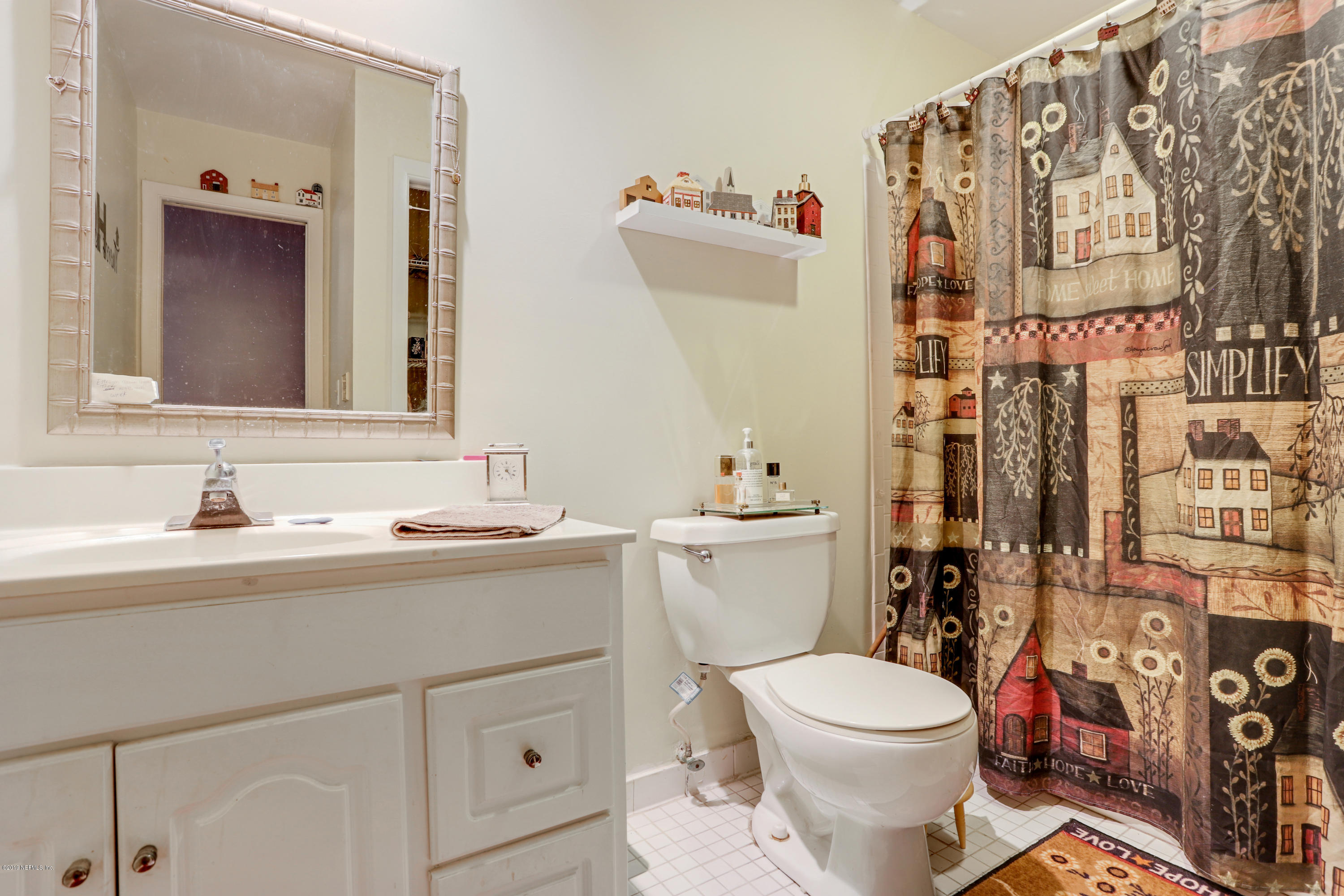 986 Bea Lane Jacksonville, FL 32220 - Photo 26 of 42 a bathroom with a toilet sink and mirror