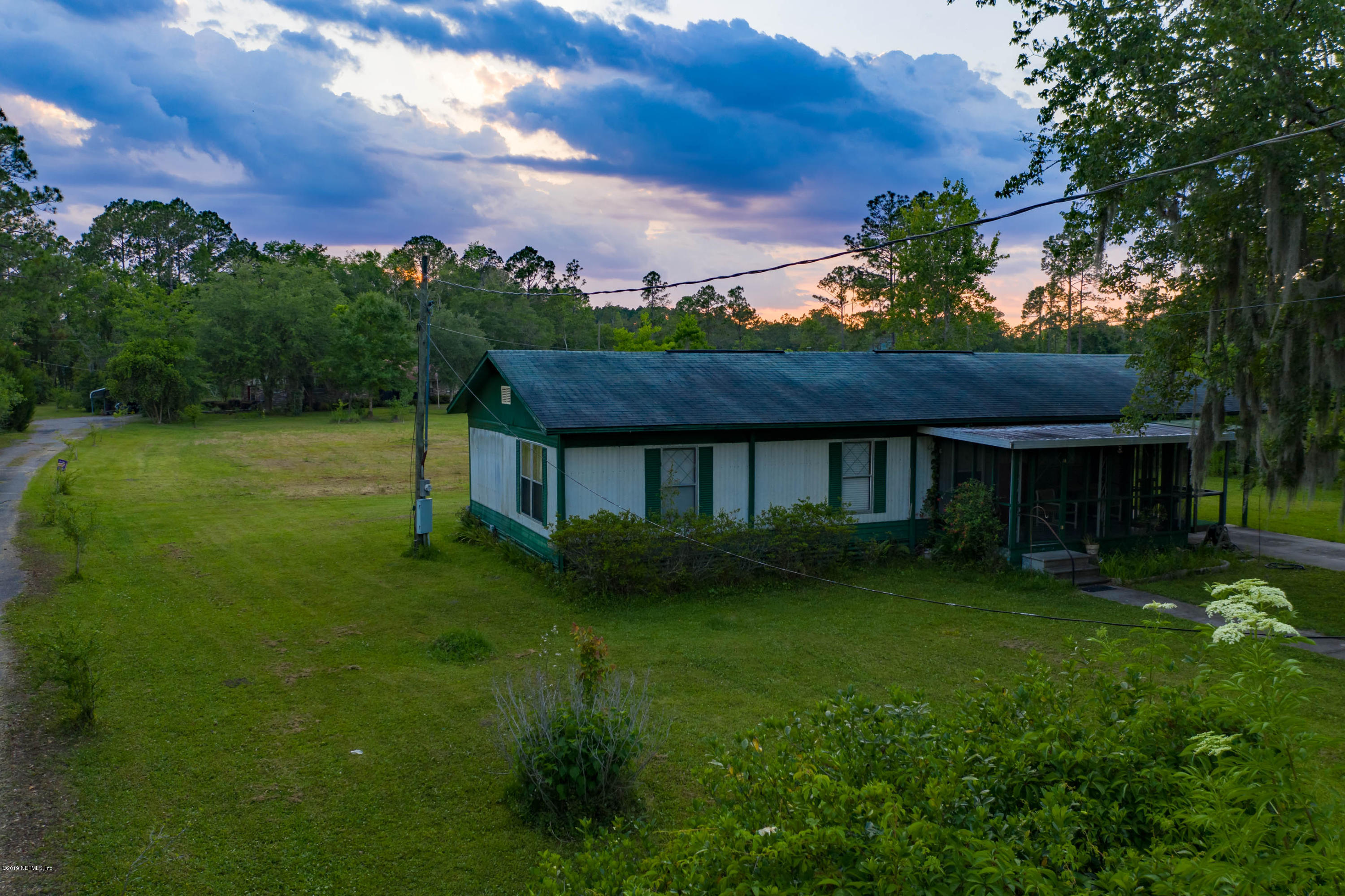 986 Bea Lane Jacksonville, FL 32220 - Photo 31 of 42 a view of a house next to a big yard