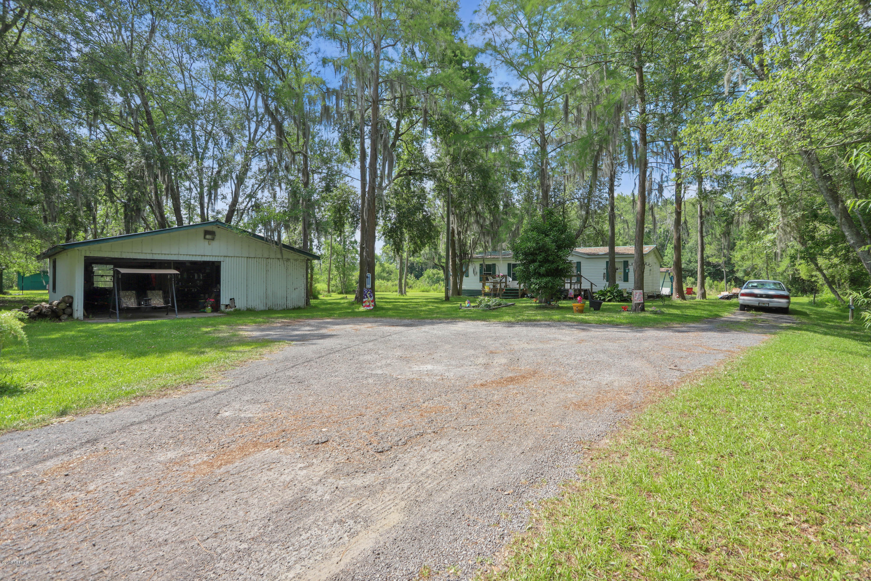 986 Bea Lane Jacksonville, FL 32220 - Photo 37 of 42 a view of a house with a yard and large trees