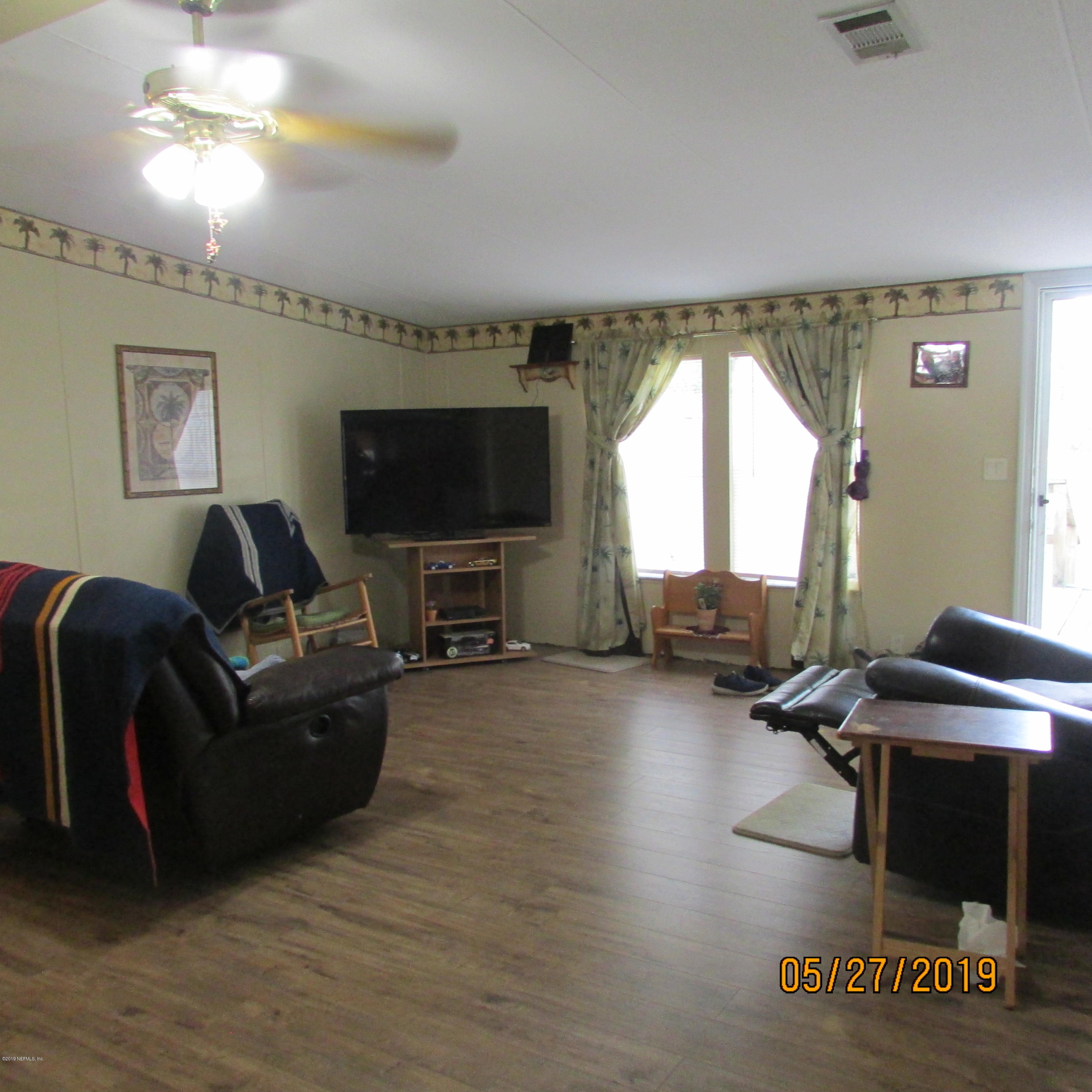 986 Bea Lane Jacksonville, FL 32220 - Photo 39 of 42 a living room with furniture and a flat screen tv