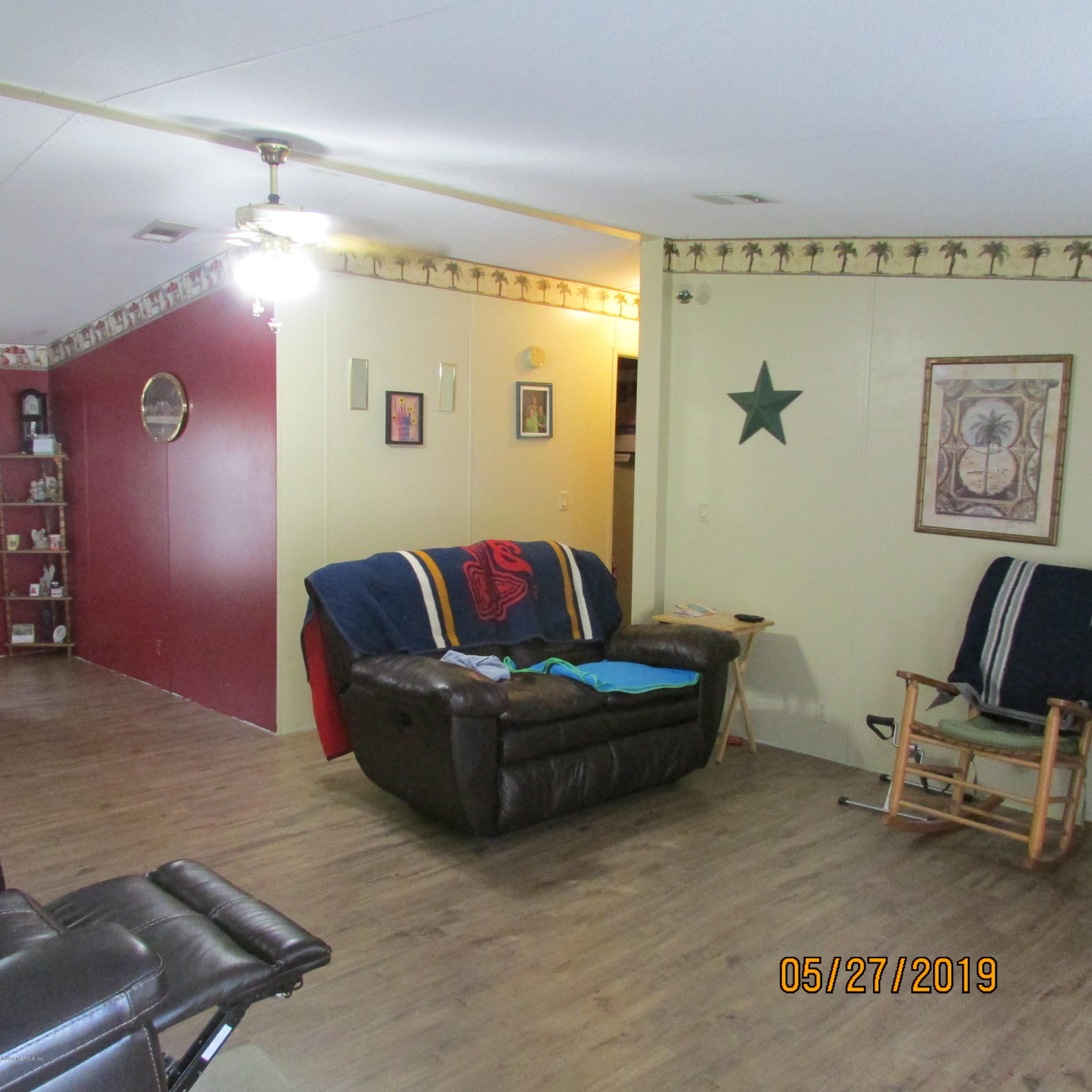 986 Bea Lane Jacksonville, FL 32220 - Photo 40 of 42 a living room with furniture and a chair