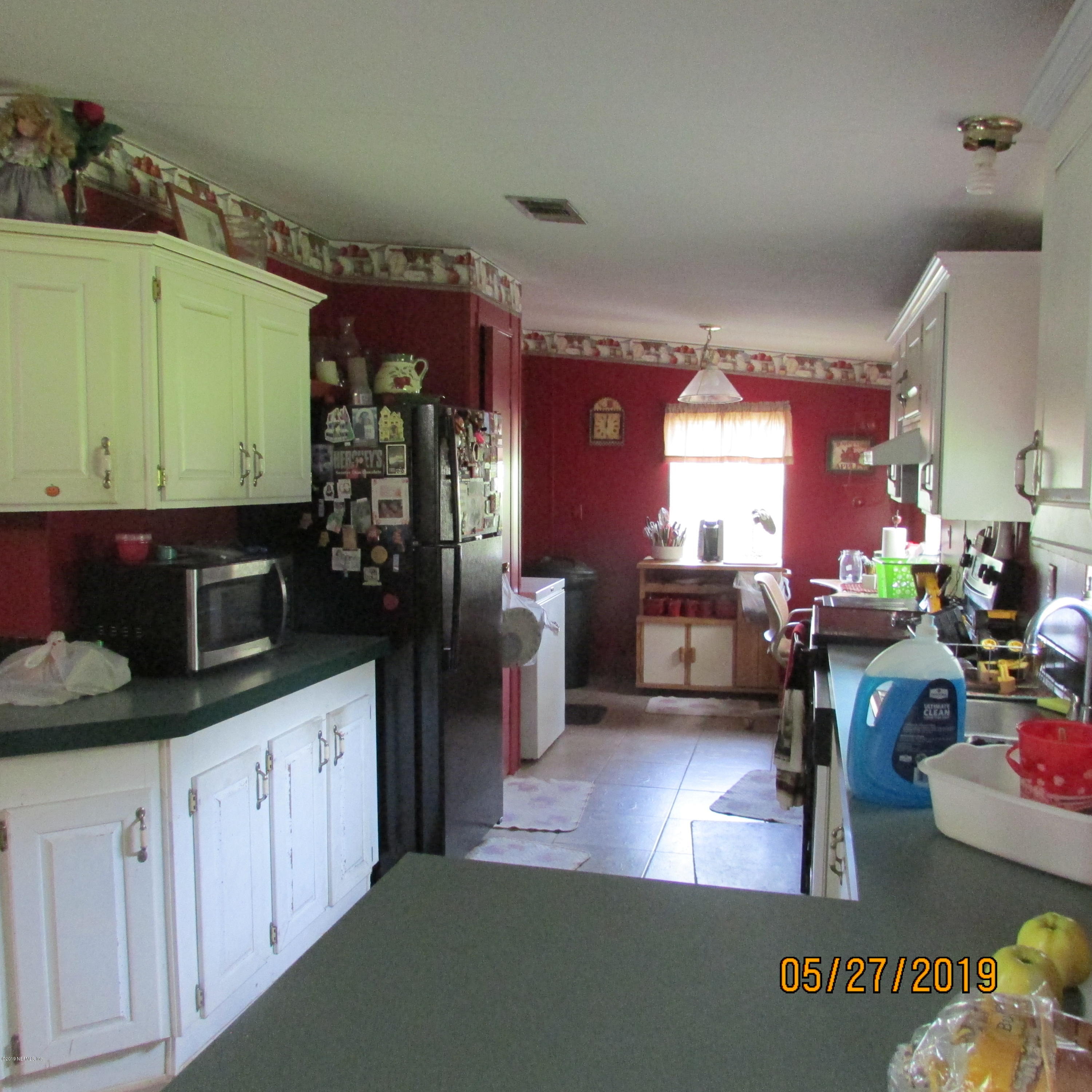 986 Bea Lane Jacksonville, FL 32220 - Photo 41 of 42 a kitchen with cabinets a sink and appliances