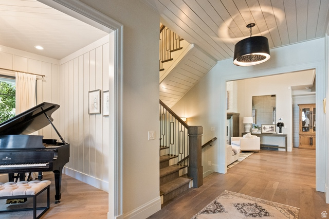 3 Carriagewood Cove, Unit 1088 Sandy, UT 84092 - Photo 13 of 79 Entryway featuring hardwood flooring, an open staircase with metal balusters, and a paneled ceiling with a decorative pendant light