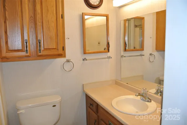 a bathroom with a toilet a sink and a shower curtain